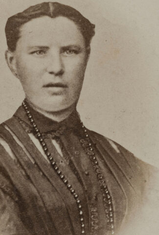 19th century sepia photograph of the head and shoulders of a woman with a strong face